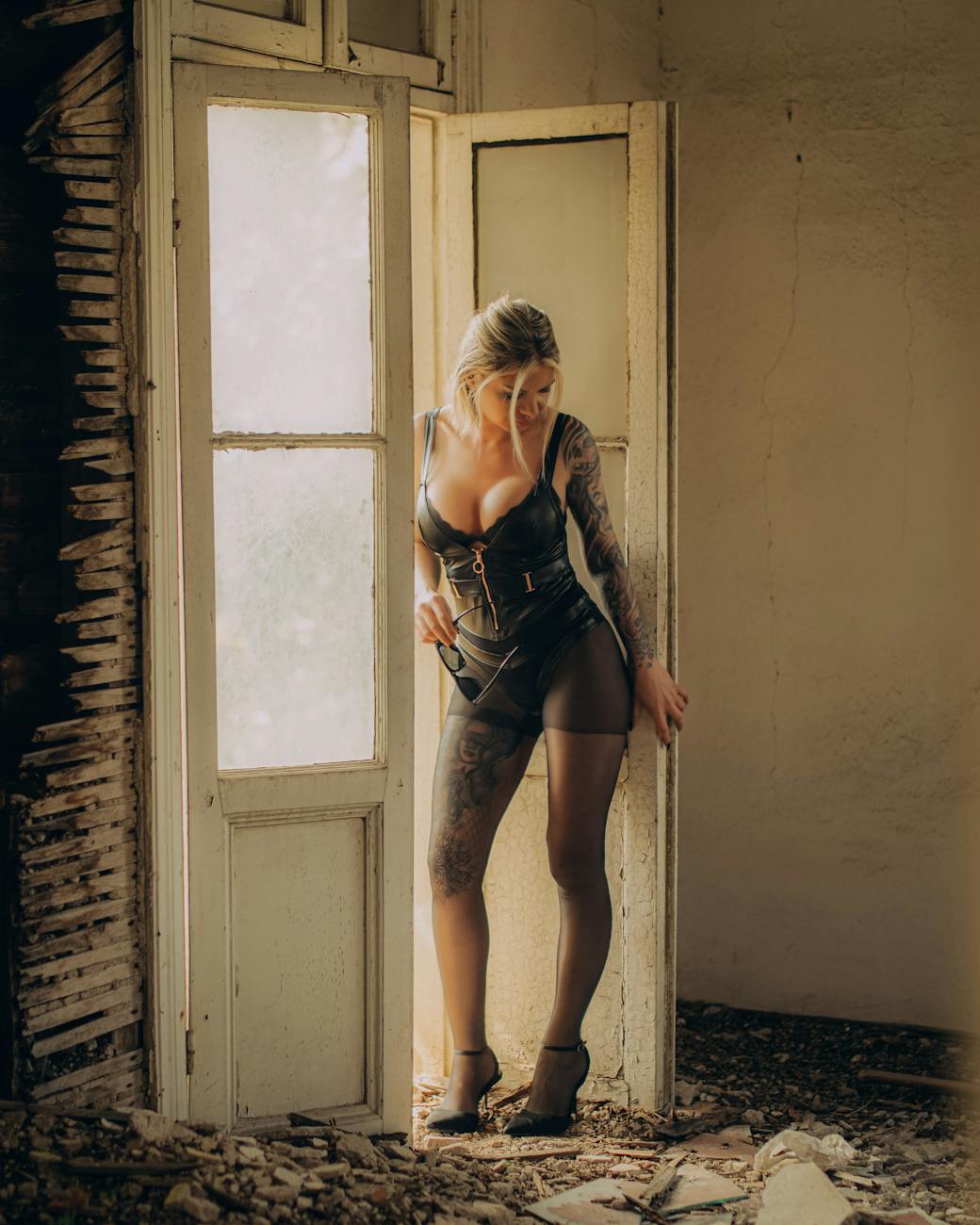 a woman in seductive clothing looking on a rubble on the floor